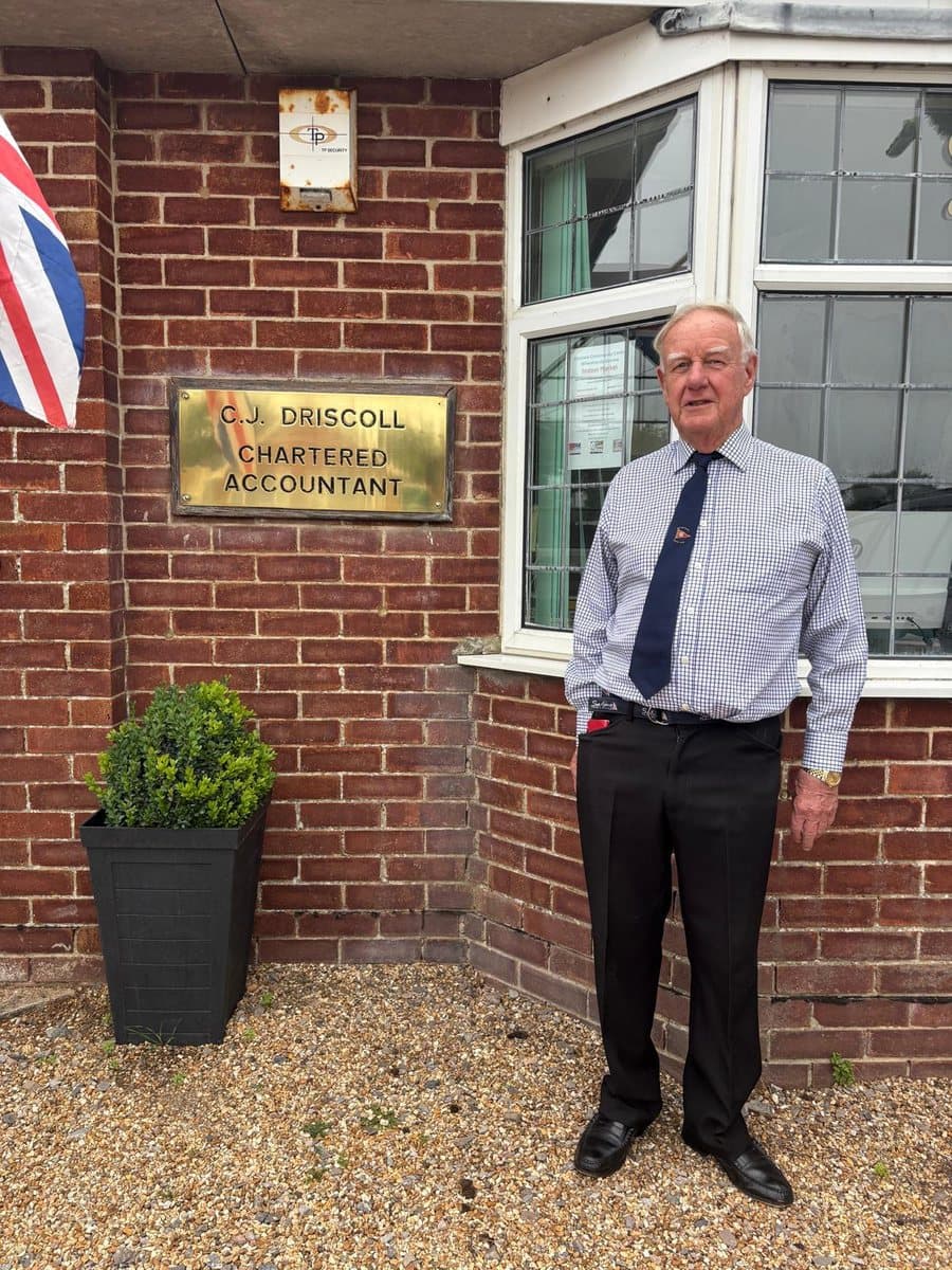 Chris Driscoll outside the practice at 19 Mengham Lane, beside the C.J. Driscoll Chartered Accountant nameplate